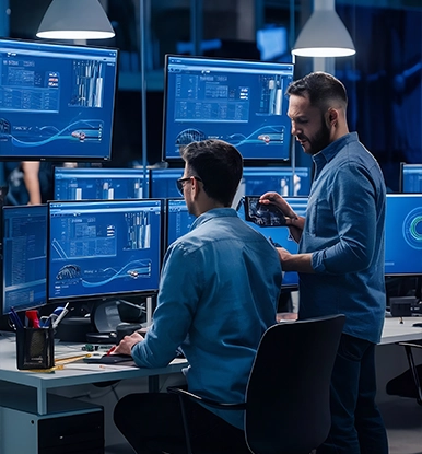 Cybersecurity professionals analyze real-time data on multiple screens to detect and prevent threats.